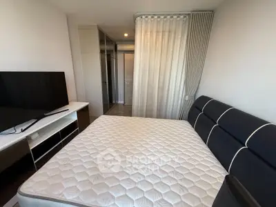 Modern bedroom with sleek design, featuring a large bed, TV, and stylish curtains for a cozy ambiance.