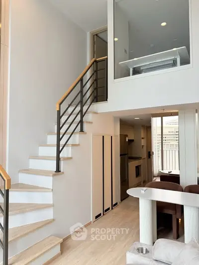 Modern duplex apartment with stylish staircase and open kitchen layout