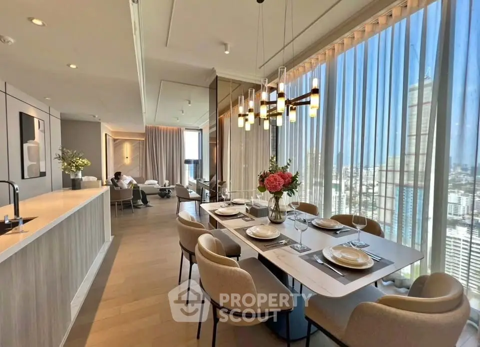 Luxurious open-plan living and dining area with stunning city views and elegant decor.