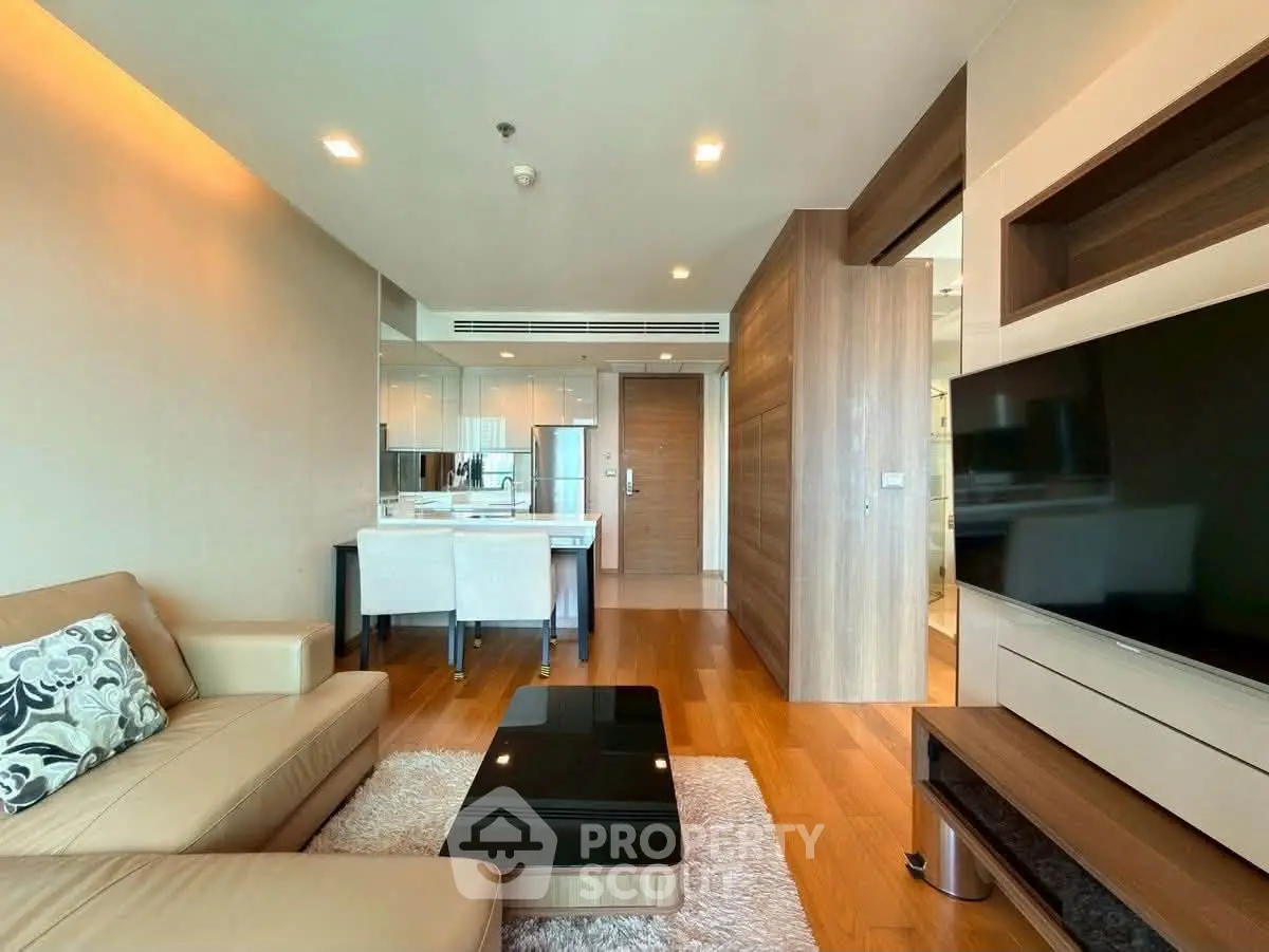 Luxurious modern living room with elegant decor and open layout, featuring a cozy sofa and sleek entertainment center.