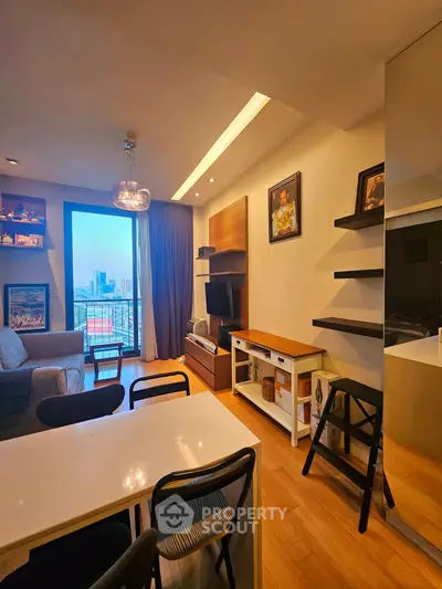 Modern living room with city view, stylish decor, and cozy seating area.