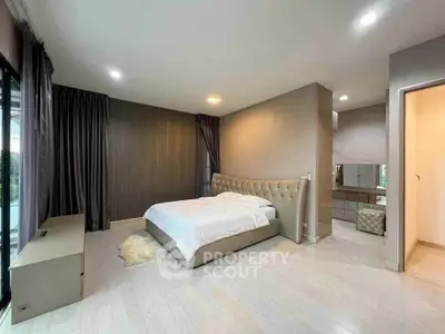 Spacious modern bedroom with elegant decor and natural light