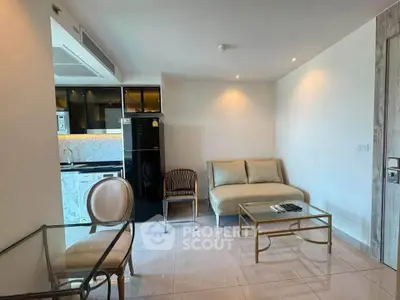 Modern living room with sleek kitchen and elegant furniture in a stylish apartment.