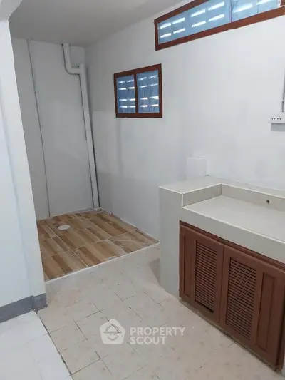 Spacious bathroom with modern fixtures and ample natural light, perfect for a refreshing start to your day.