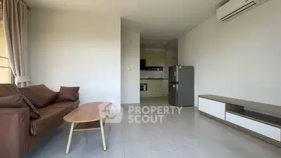 Modern living room with sleek furniture and open kitchen layout