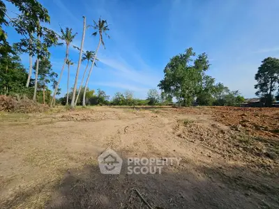 Expansive land plot with clear skies, ideal for development opportunities.