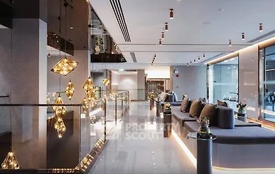 Luxurious modern lobby with elegant lighting and plush seating in a high-end building.