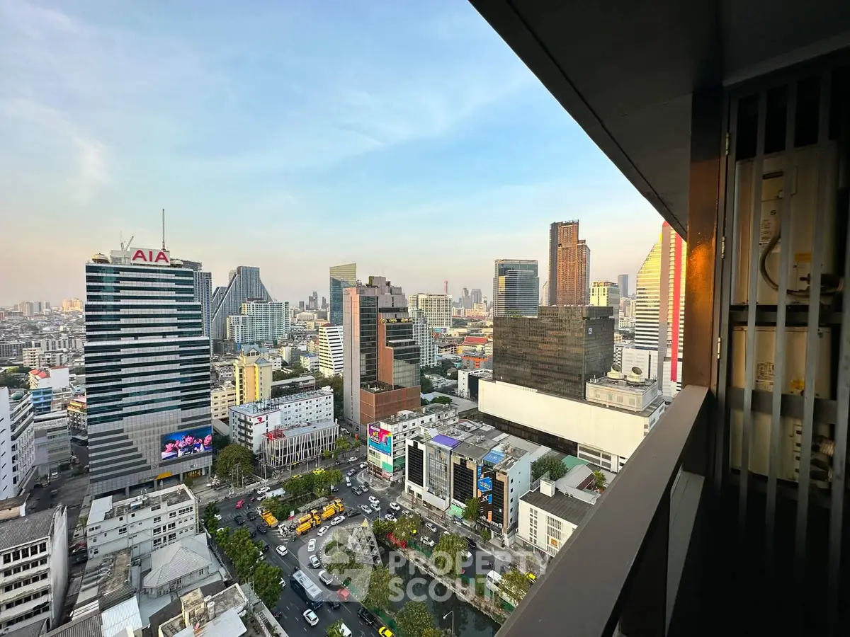 Stunning cityscape view from high-rise balcony overlooking bustling urban skyline.