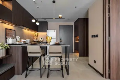 Modern kitchen with sleek design, featuring an open layout and stylish bar seating, perfect for contemporary living.