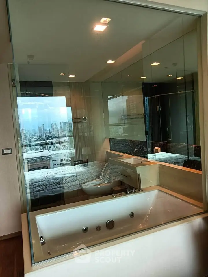 Luxurious bathroom with city view and modern bathtub in high-rise apartment.