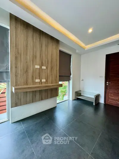 Modern minimalist interior with sleek wood accents and large windows