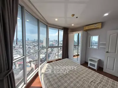 Stunning bedroom with panoramic city views and modern furnishings.