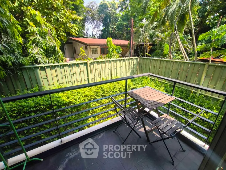 Charming balcony with lush garden view, perfect for relaxing outdoors.