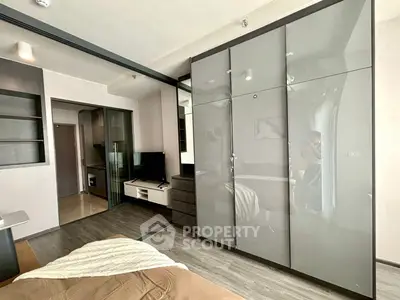 Modern bedroom with sleek wardrobe and cozy decor in a stylish apartment