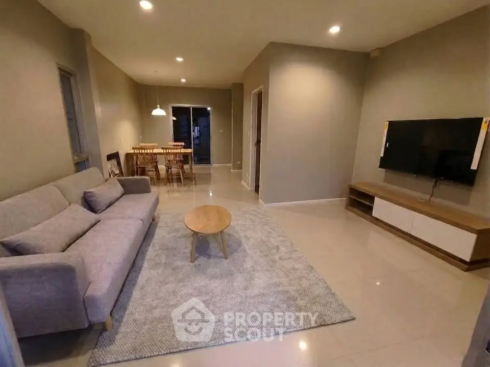 Spacious living room with modern decor and dining area, perfect for family gatherings.