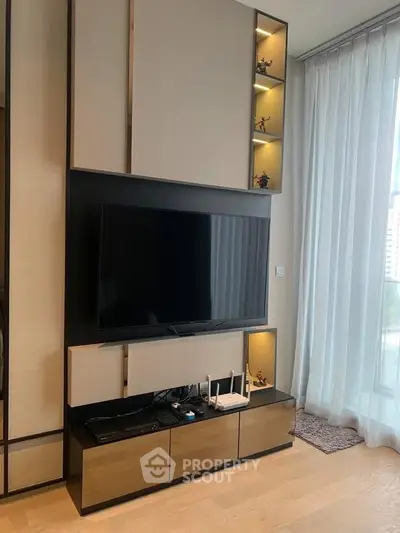 Modern living room with sleek TV unit and floor-to-ceiling windows