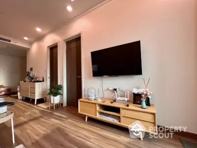 Modern living room with wooden flooring and wall-mounted TV