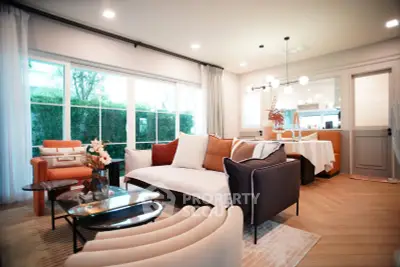 Stylish modern living room with elegant furniture and large windows offering natural light.