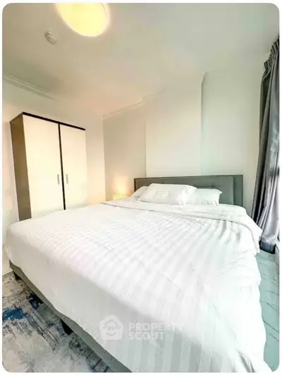 Spacious bedroom with modern decor and ample natural light