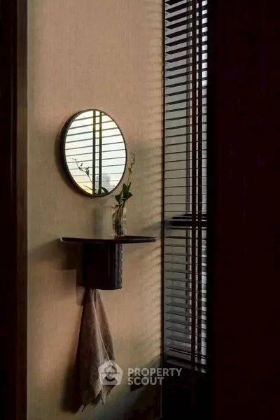 Stylish bathroom corner with round mirror and elegant decor