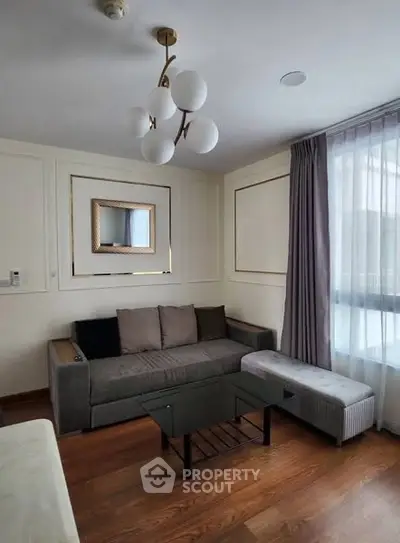 Elegant living room with modern chandelier and cozy seating area