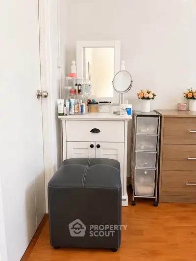 Cozy bedroom corner with vanity table and storage drawers, perfect for organizing beauty essentials.