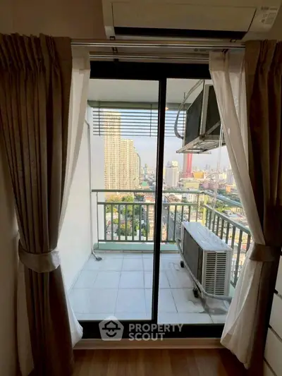 Stunning city view from a high-rise balcony with air conditioning unit, perfect for urban living.