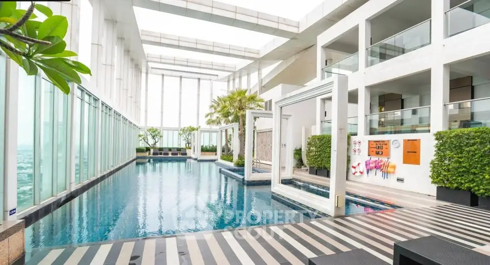 Luxurious rooftop pool with modern design and stunning city views in a high-rise building.