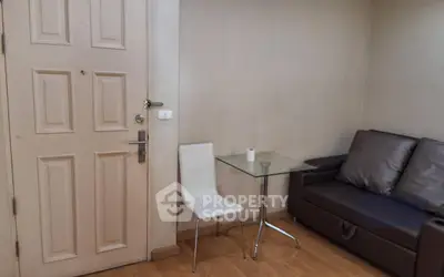 Cozy living room corner with modern sofa and glass table