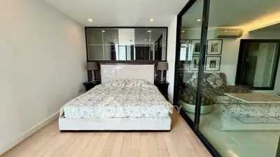 Modern bedroom with glass partition and stylish decor