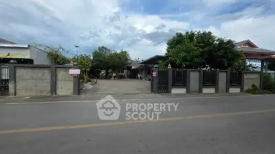 Charming suburban home with spacious driveway and lush greenery, perfect for family living.