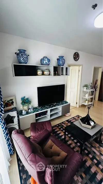 Charming living room with elegant decor and modern entertainment setup.