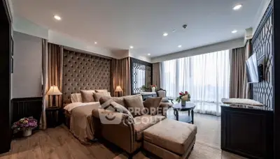 Luxurious living room with elegant decor and large windows offering natural light.