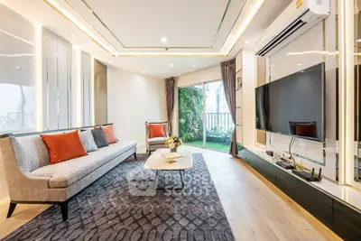 Luxurious living room with modern decor and garden view, featuring elegant furniture and large TV.