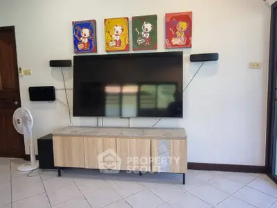 Modern living room with wall-mounted TV and stylish cabinet