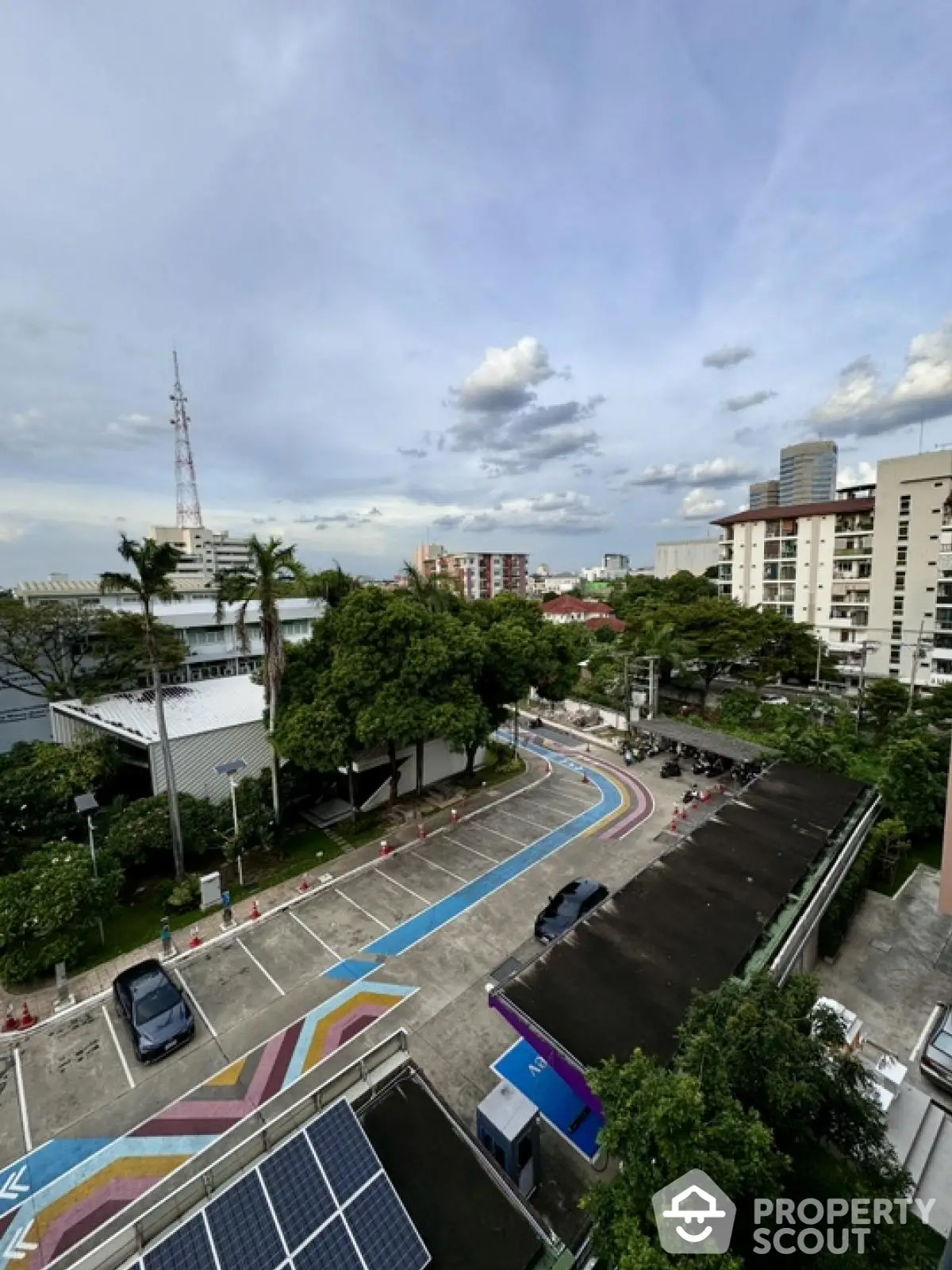 Stunning urban view with vibrant parking area and lush greenery