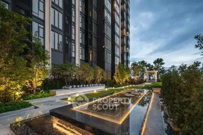 Luxurious modern building exterior with elegant water feature and lush greenery
