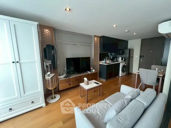 Modern living room with sleek furniture and integrated kitchen appliances