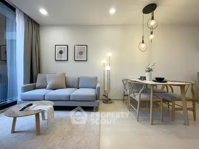 Modern living room with cozy sofa and elegant dining area, perfect for relaxation and entertaining.
