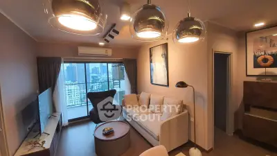 Modern living room with city view, stylish lighting, and cozy seating area in a high-rise apartment.