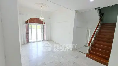 Spacious living room with elegant chandelier and marble flooring