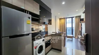 Modern open-layout kitchen and living room with sleek appliances and stylish decor