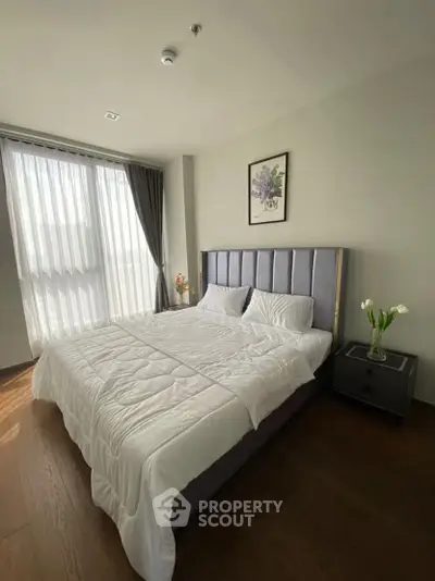 Spacious bedroom with elegant decor and natural light