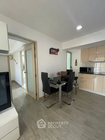 Modern dining area with sleek furniture and open kitchen layout