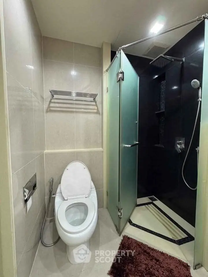Modern bathroom with glass shower and sleek fixtures.
