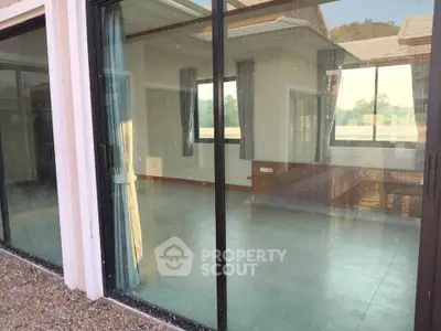 Spacious empty room with large glass windows offering scenic views, perfect for natural light lovers.