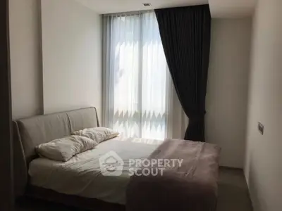 Cozy bedroom with soft lighting and elegant curtains, perfect for relaxation.