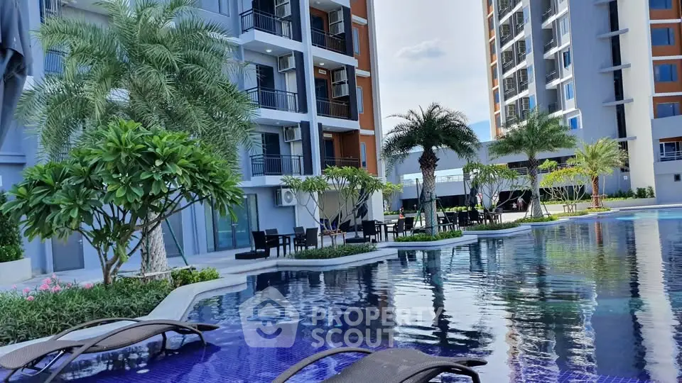 Luxurious apartment complex with stunning pool and lush greenery