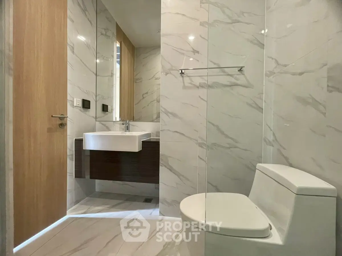 Modern bathroom with sleek marble tiles and contemporary fixtures