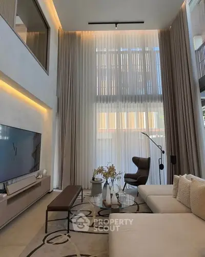 Luxurious high-ceiling living room with elegant decor and modern furniture